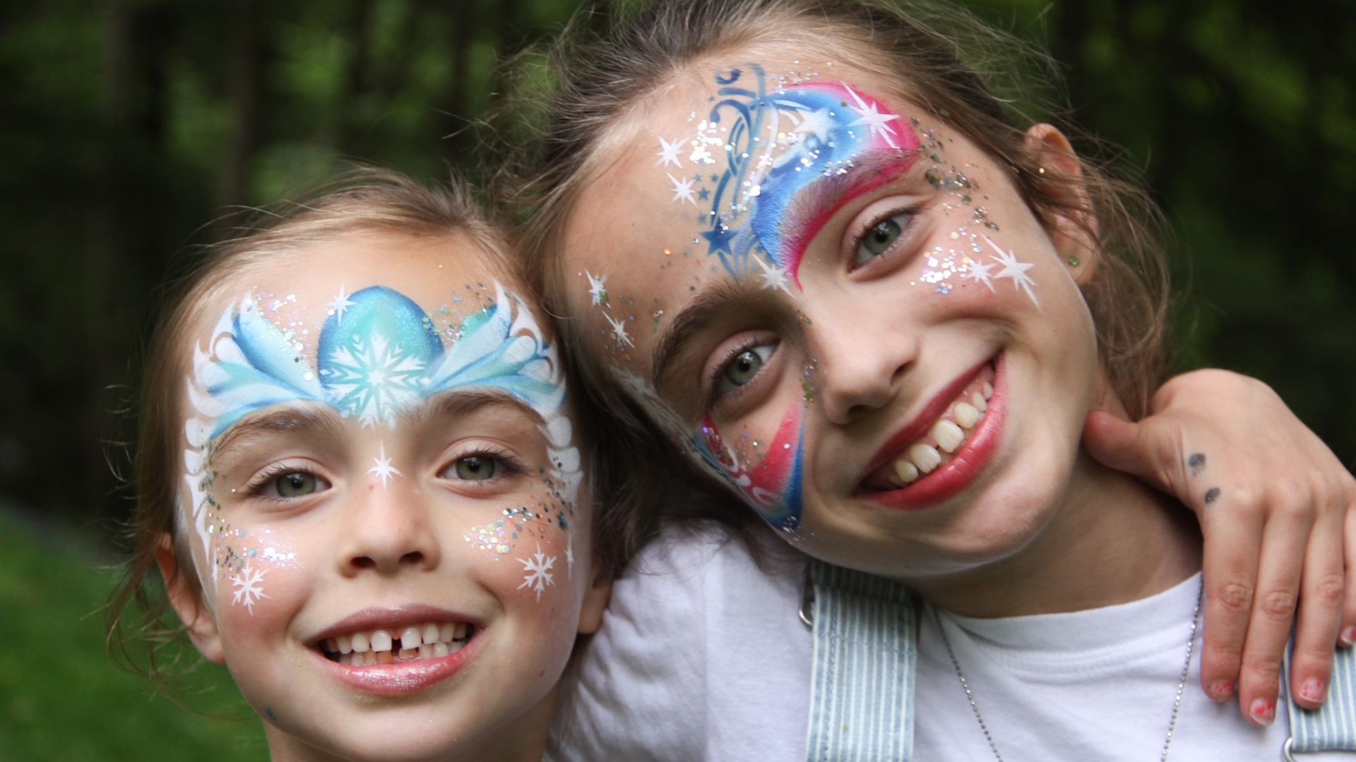 Two children with face paintings.